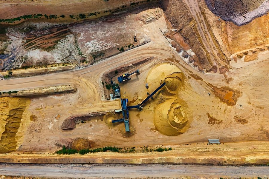 Aerial view of a quarry with stockpiles and screening plant